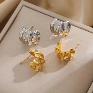 French vintage S925 silver wavy hoop earrings in gold and silver finish on a jewelry box