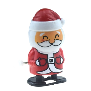 Close-up of a wind-up Santa Claus toy with red plastic body and metal winding key