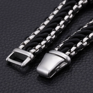 Macro shot of stainless steel clasp and black braided nylon multilayer bracelet