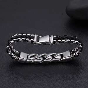 Close-up of multilayered black leather rope and polished steel chain bracelet for men