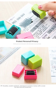 Detail of colorful privacy roller stamps with dust covers on a wooden table