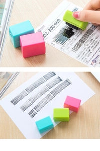 Green roller stamp masking personal data on a shipping label alongside colorful variants