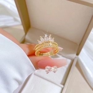 Adjustable gold crown ring featuring LOVE engraving and shimmering white zircons