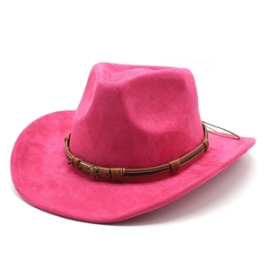 Detail of hot pink suede western cowboy hat with brown belt and metal star studs