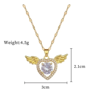 Detailed view of gold wing heart pendant with size measurements and diamond accents