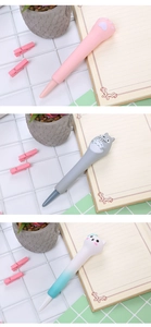 Macro detail of cute squishy slow-rebound pens featuring Totoro and cartoon cat designs