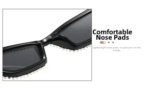 Close-up of integrated nose pads and rhinestone trim on classic black cat-eye sunglasses