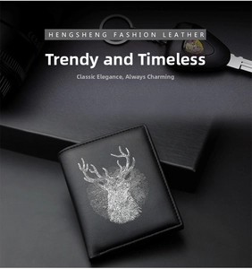 Detail of slim black leather wallet with white deer print next to car keys