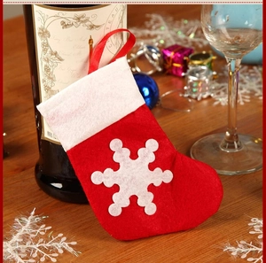 Red felt Christmas stocking cutlery holder with white snowflake and hanging loop