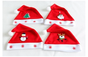 Detail view of 4 plush Christmas hats featuring Santa, Snowman, Reindeer, and Tree motifs