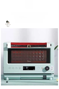 Close-up of festive Christmas oven handle covers with red fabric and black belt design