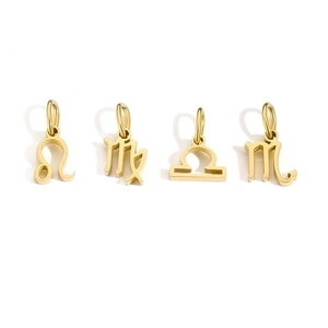 Detail of four golden stainless steel zodiac charms including Leo and Scorpio symbols