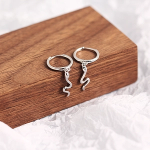 Detail showing snake-shaped S925 sterling silver earrings with small zircon accents