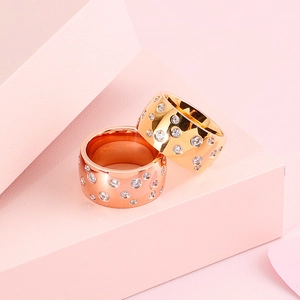 Gold and rose gold stainless steel couple rings with crystals on pink geometric steps
