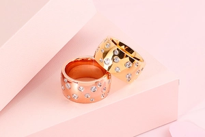 Macro shot of gold and rose gold stainless steel rings with sparkling cubic zirconia inlay
