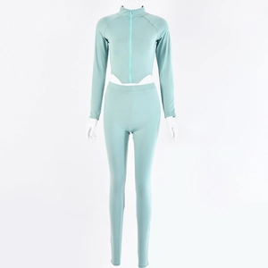 Detail of mint green two-piece tracksuit featuring a zipper top and high-waist leggings