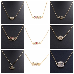 Detailed view of assorted gold necklaces with colorful zircon moon and star pendants