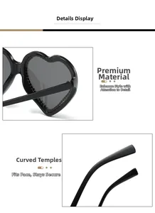 Detail view of heart-shaped sunglasses featuring glossy black frames and curved temples