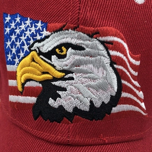 Close-up of red cotton cap featuring eagle embroidery and American flag detail