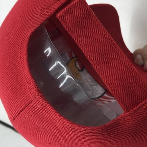 Detail of red baseball cap with adjustable velcro strap and San Francisco team interior