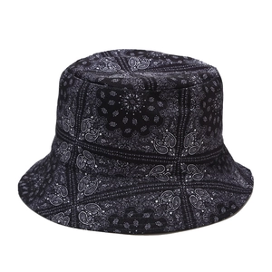 Reversible black paisley cotton bucket hat for women providing outdoor sun protection