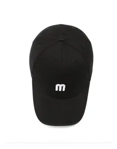 Top down view of black cotton baseball cap showing detailed white letter m embroidery