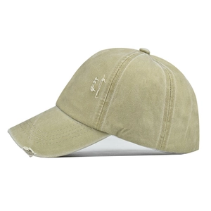 Detail view of washed cotton ponytail baseball cap with distressed rips and embroidery