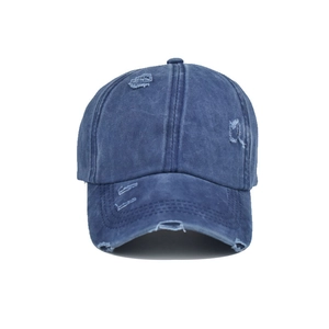 Detail of navy blue washed cotton baseball cap with vintage distressed ripped edges