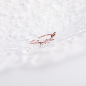 Detail of rose gold flower ring featuring pink crystals and white pavé zircon stones