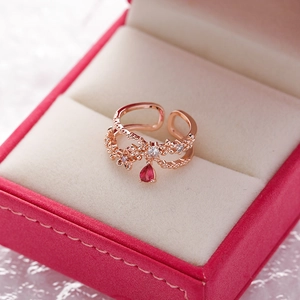 Rose gold flower open ring with red teardrop crystal on pink velvet display case