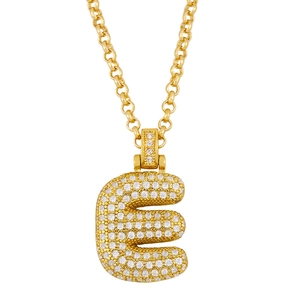 Close-up of gold-plated letter E pendant with pave-set crystals and thick curb chain