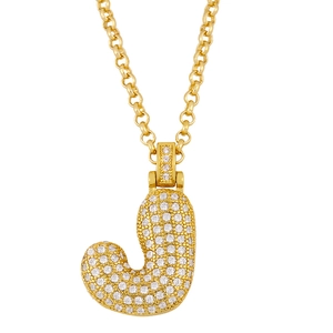 Detailed view of a gold-plated necklace featuring a pavé-set crystal letter J pendant