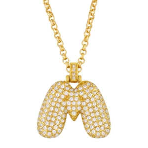 Macro shot of bubble-style letter M pendant in gold plating with pavé zircon setting