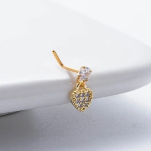 Macro shot of gold stainless steel nose stud featuring a zircon heart pendant