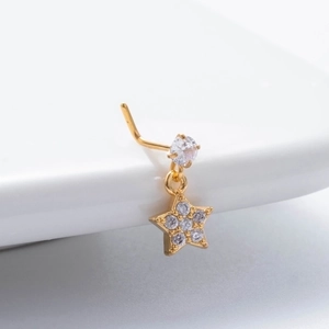 Detailed view of a gold star nose stud with sparkling zircon pendant and L-shape post