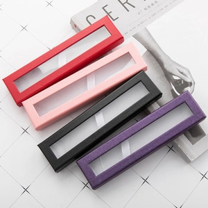 Close-up of four rectangular jewelry boxes in red, pink, black and purple with windows