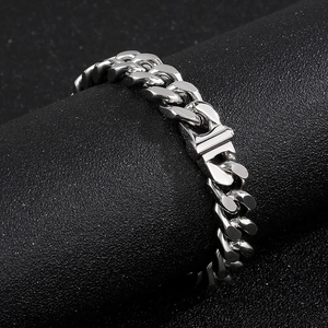 Macro view of polished silver cuban link chain bracelet with a secure box clasp