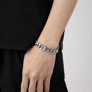 Mens silver stainless steel Cuban link chain bracelet featuring faceted metal links