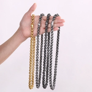 Detailed close-up of gothic stainless steel skull chain necklaces with lobster clasps