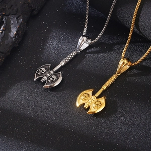 Detail of punk style skull axe pendants in silver and gold steel with box chains
