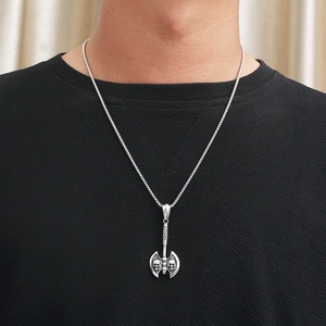 Punk rock silver double-headed axe pendant necklace with skull detail worn by male model