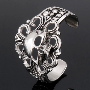 Detailed macro view of 316L stainless steel skull cuff bangle with ornate cutout floral patterns