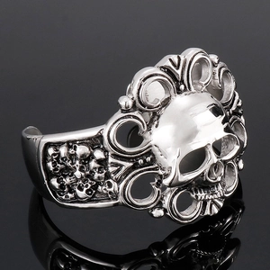 Macro side view of vintage stainless steel skull ring with intricate hollow engraving