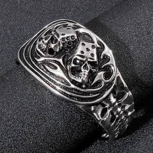 Macro shot of punk style stainless steel skull and dice ring with vintage finish