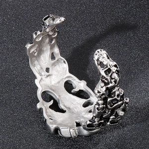Close-up of gothic silver skull textured open ring with detailed hollow-out carvings