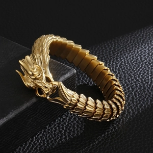 Golden dragon scale bracelet with detailed head carving in stainless steel on black leather