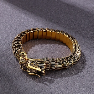 Detailed close-up of a vintage gold dragon head bracelet with textured metal scales