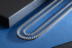 Detailed close-up of different widths of polished stainless steel Cuban link chains