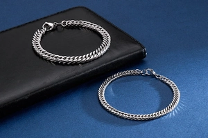 Close-up of thick and thin silver stainless steel curb chain bracelets for men
