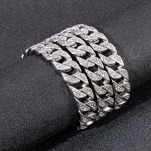 Close-up of hip hop silver Cuban link bracelet with micro-paved rhinestones on black